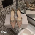 Women's pointed patent leather stiletto high heels with pearl detail on the heel.