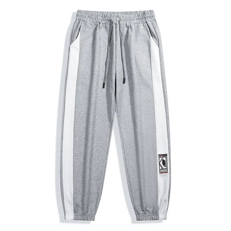 Men's casual wide leg fleece lined trousers in black, front view, showing drawstring waist and straight leg silhouette