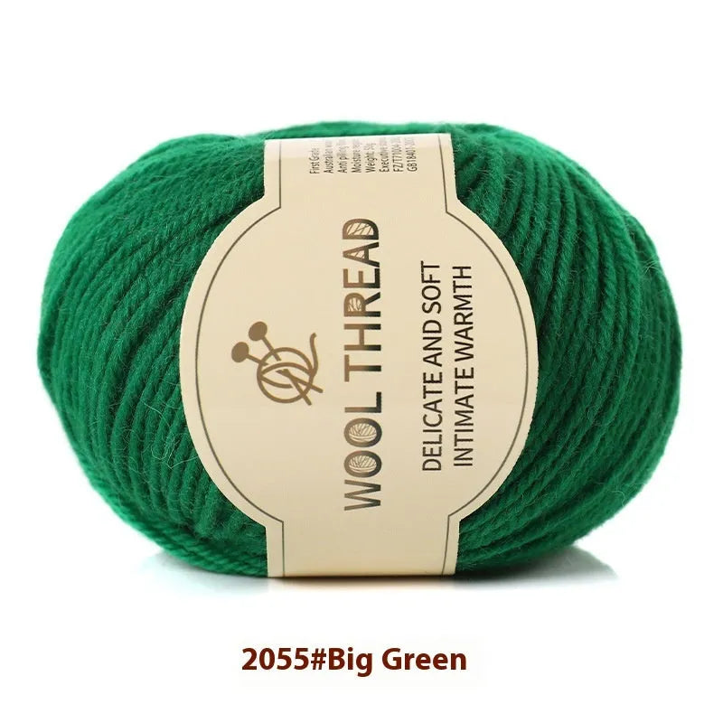 One roll of beige domestic wool hand-knitting yarn for size 10 needles next to knitting needles.