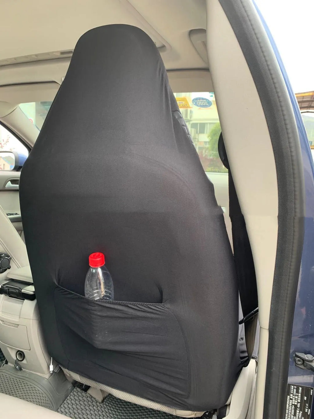 Black quilted automotive seat cover made from PU and polyester fabric, shown with plastic fitting hooks.