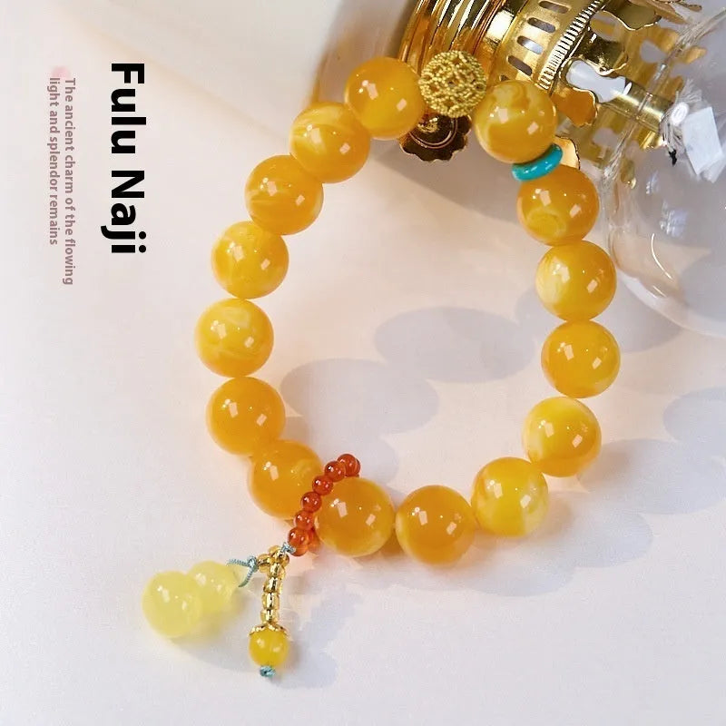 Natural beeswax Gourd Fu Lu bracelet in two sizes 12mm and 6mm on plain background
