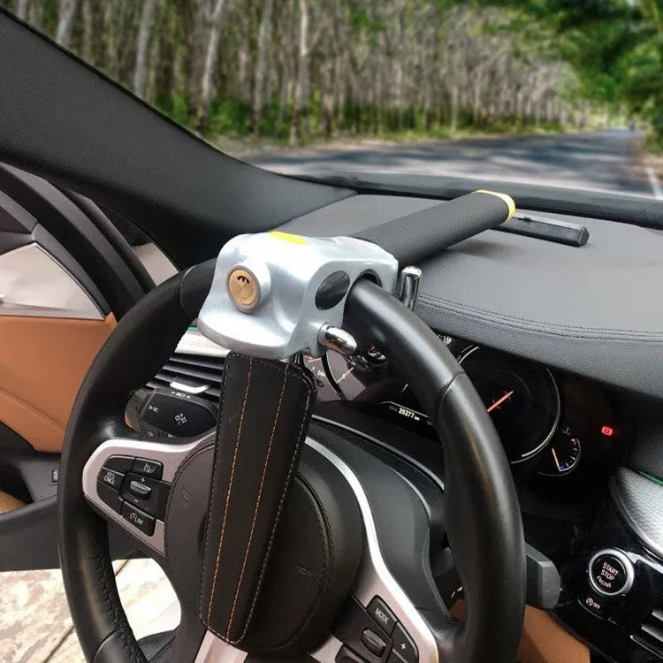 Universal car steering wheel lock in black gold, steel and aluminium alloy with copper core alarm, includes keys and wrench