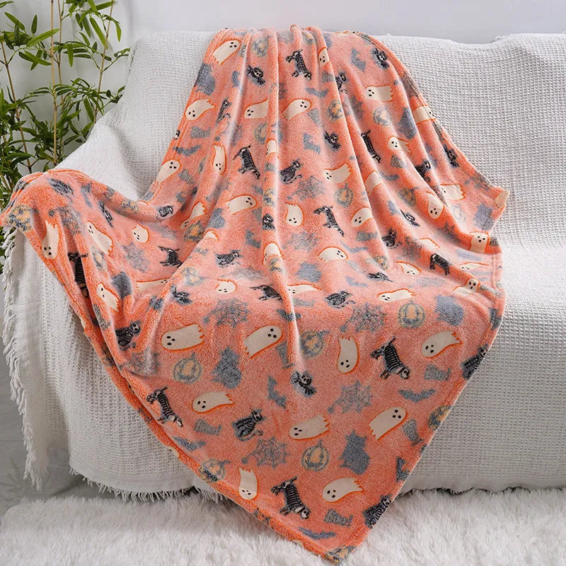Colourful cartoon print flannel blanket shown draped over a sofa and next to an air conditioner unit.
