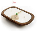 Retro wooden basin containing a lavender-coloured soy wax candle with three visible wicks.