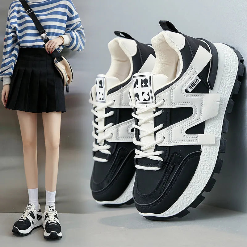 Low top running sneaker in white with round toe and lace-up front on rubber sole
