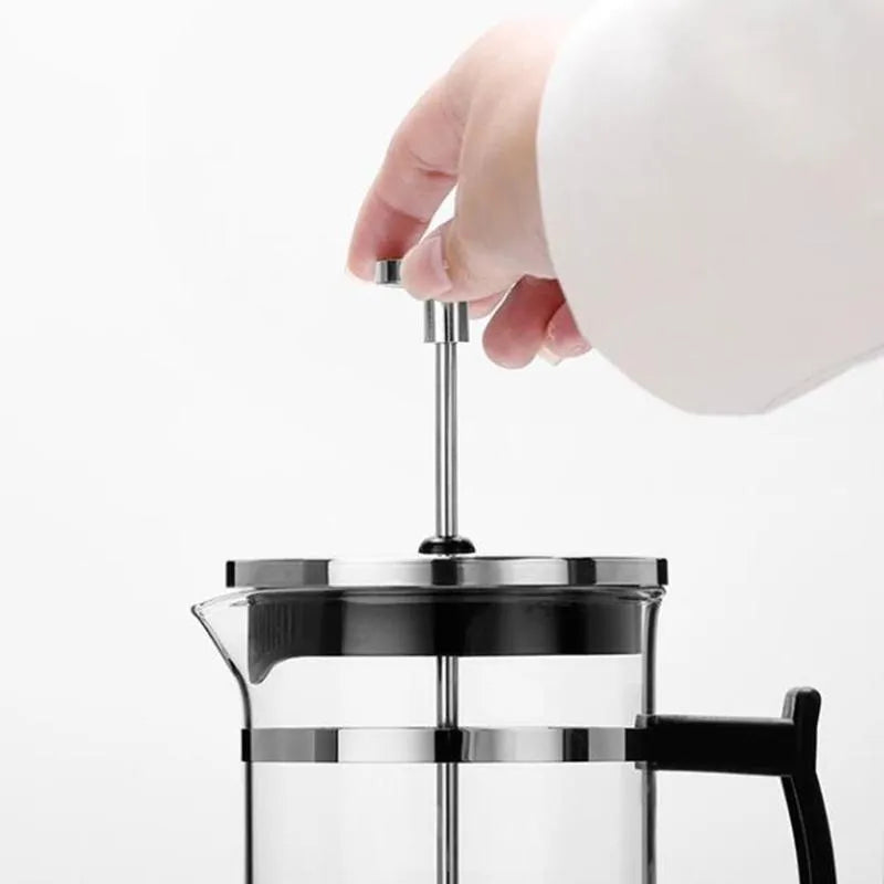 Compact stovetop espresso maker with glass upper section and stainless steel base