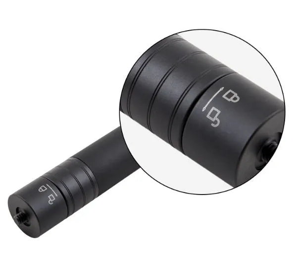 Black retractable aluminium selfie stick extended in hand next to a smartphone.