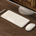White ultra-thin wireless keyboard and mouse set with USB receiver on a wooden desk