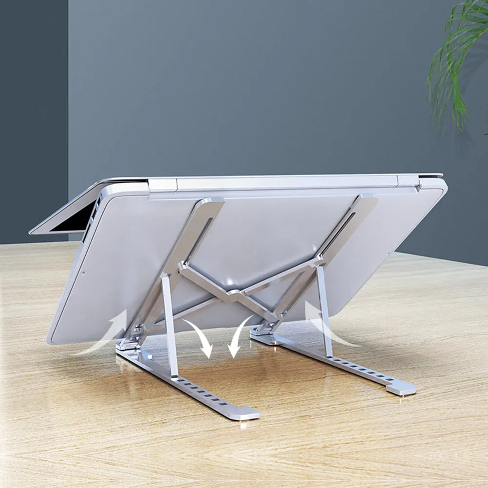 Silver foldable aluminium laptop stand holding a MacBook at an adjusted angle