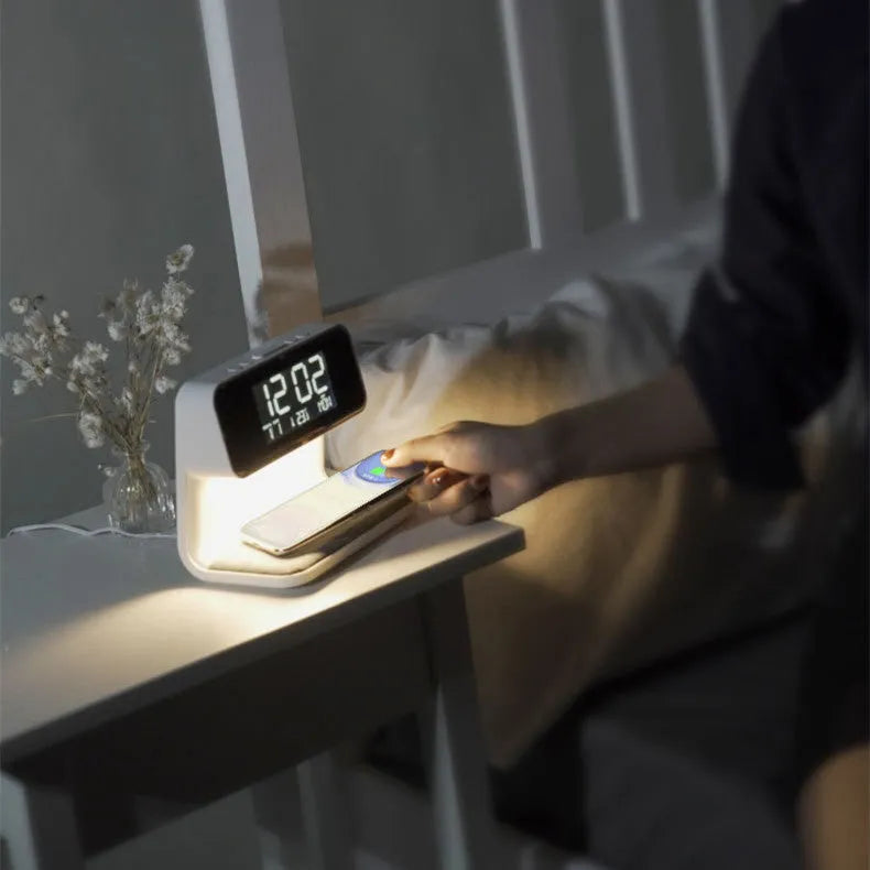 White bedside lamp with integrated wireless charging pad and LCD alarm clock display