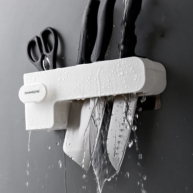 White plastic kitchen knife storage rack with compact dimensions on kitchen worktop