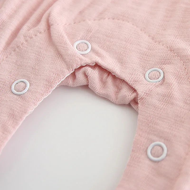 Pink cotton baby girls romper suit with embroidery, long sleeves, and single-breasted closure