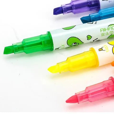 Six double-headed watercolour highlighters showing pink, orange, yellow, green, blue, and purple colours with plug-in caps