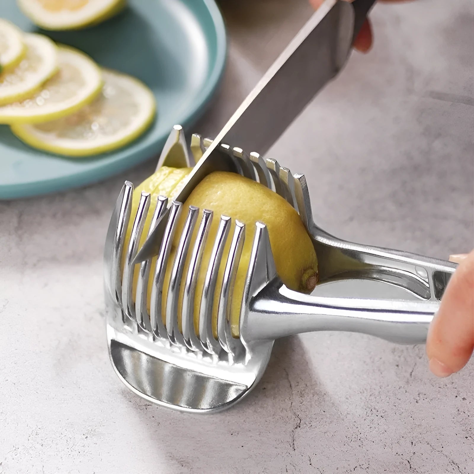 Silver plastic lemon slicer kitchen utensil for cutting uniform citrus slices