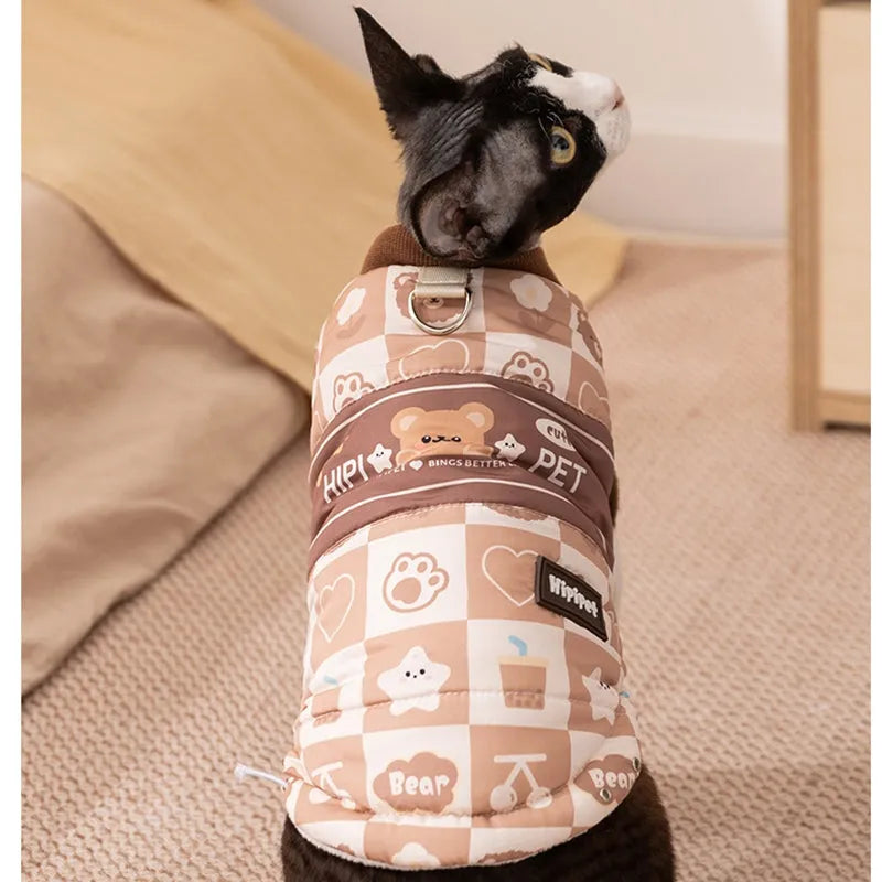 Quilted two-legged pet vest with leash ring in brown bear print or geometric red-green, sizes XS-XXL.