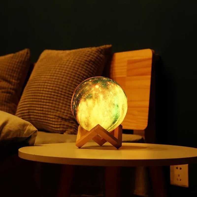 3D-printed spherical lunar night light on a surface, showing its colour-changing LED glow and remote control.
