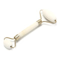 Natural jade facial massage roller on a light background showing smooth green stone and handle