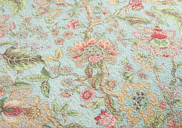 Blue American floral and bird pattern quilted cotton bedspread set on a bed, showing detailed stitching and 230x250cm size.