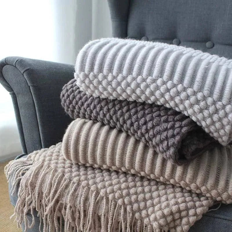 Small rectangular polyester nap blanket in dark grey, khaki, and light grey colours, measuring 127 by 170 cm.
