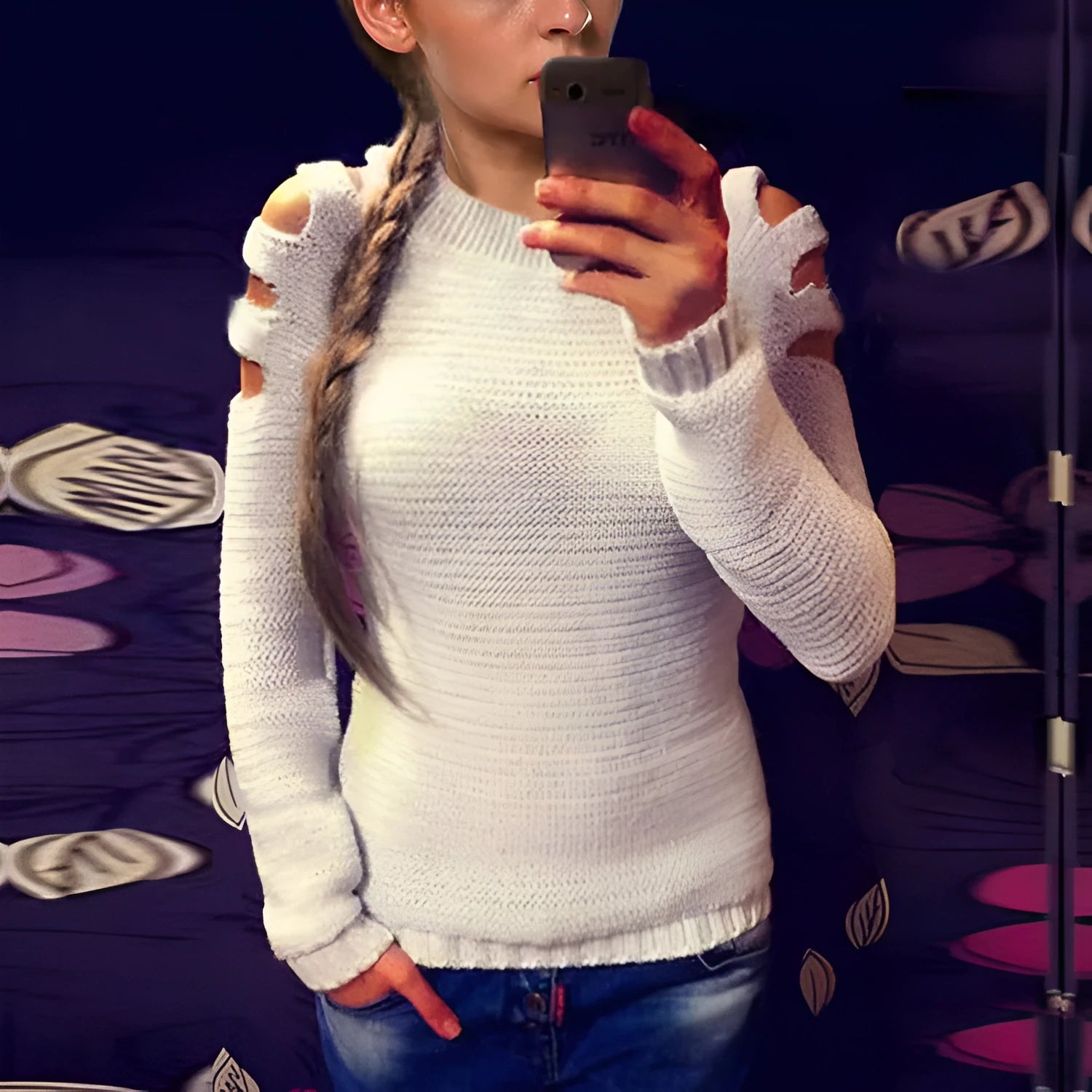 Women's grey hollow-out crochet long sleeve knit shirt on a hanger.