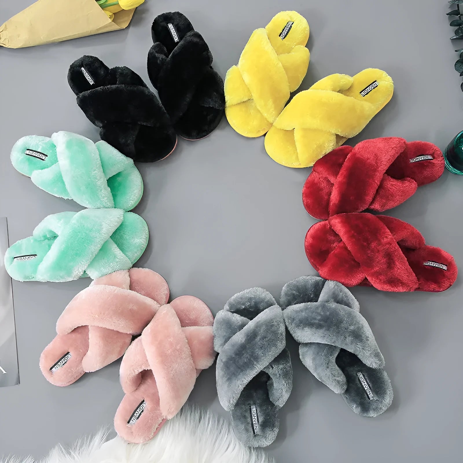Women's cross open-toe fur slippers in assorted colours on a patterned non-slip sole.