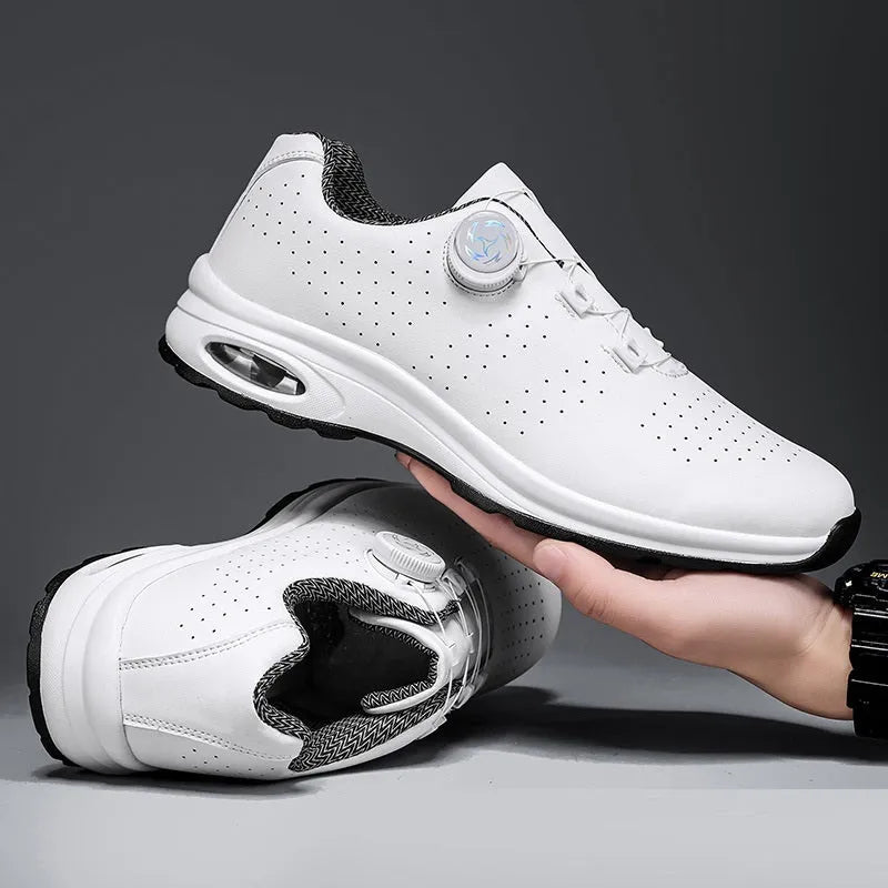 Black and white low-top tennis shoes with mesh upper and composite sole.