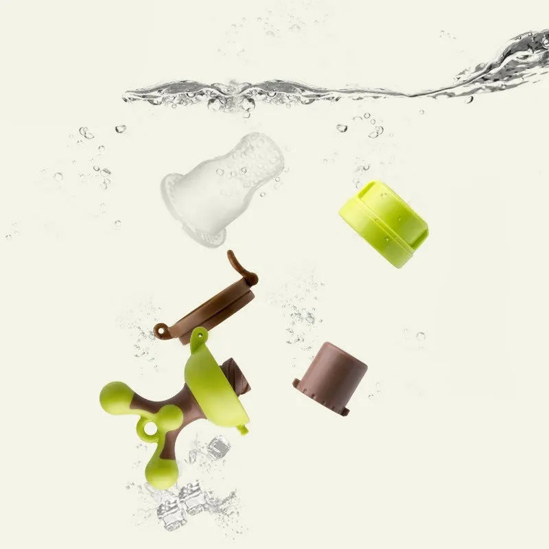 Green baby bite trainer with textured polypropylene body and silicone handles for infant teething
