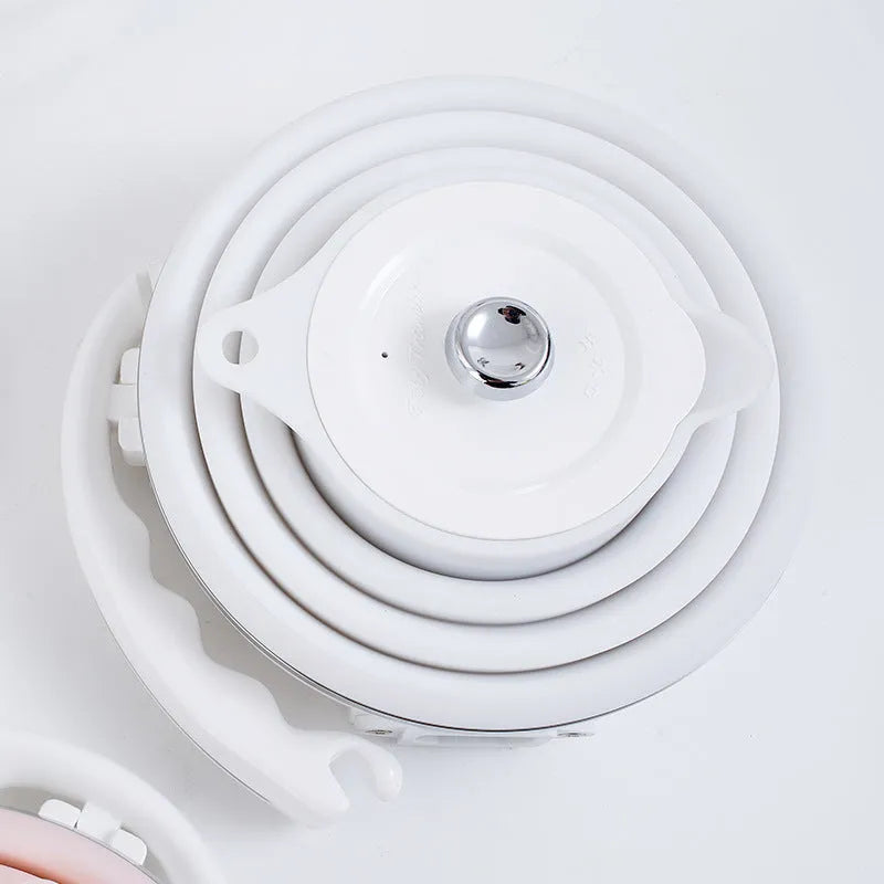 Foldable electric kettle in collapsed position showing compact 50mm height, silicone body, and power cord