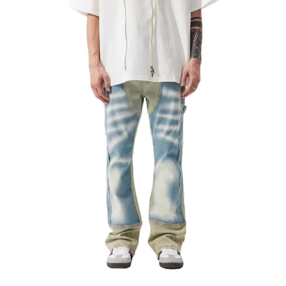 Yellow and blue retro patchwork jeans with a splash-ink damaged design on a mannequin.