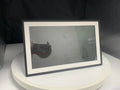 White 15.6 inch smart digital photo frame with Full HD screen on a wooden desk.