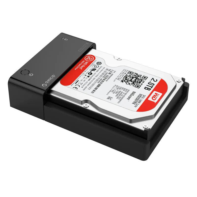 Black plastic 2.5 inch SATA hard drive enclosure with USB cable on a desk