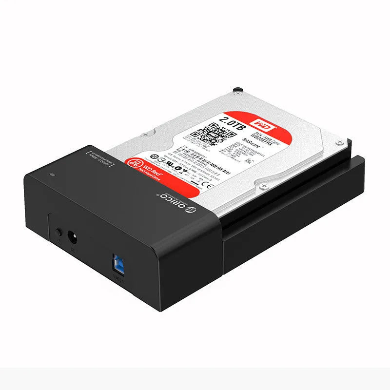 Black plastic 2.5 inch SATA hard drive enclosure with USB cable on a desk