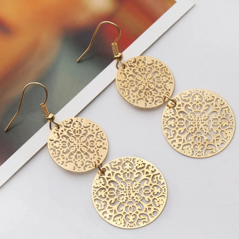 Women's gold round hollow dangle earrings made from zinc alloy, 4.5 by 8 cm, one pair