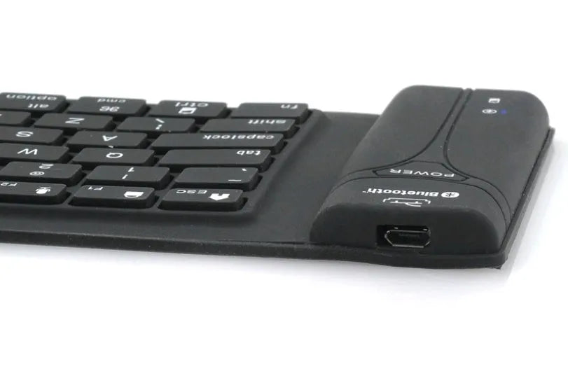 Black Bluetooth folding silicone keyboard with 108 keys and IP67 waterproof rating placed on a desk