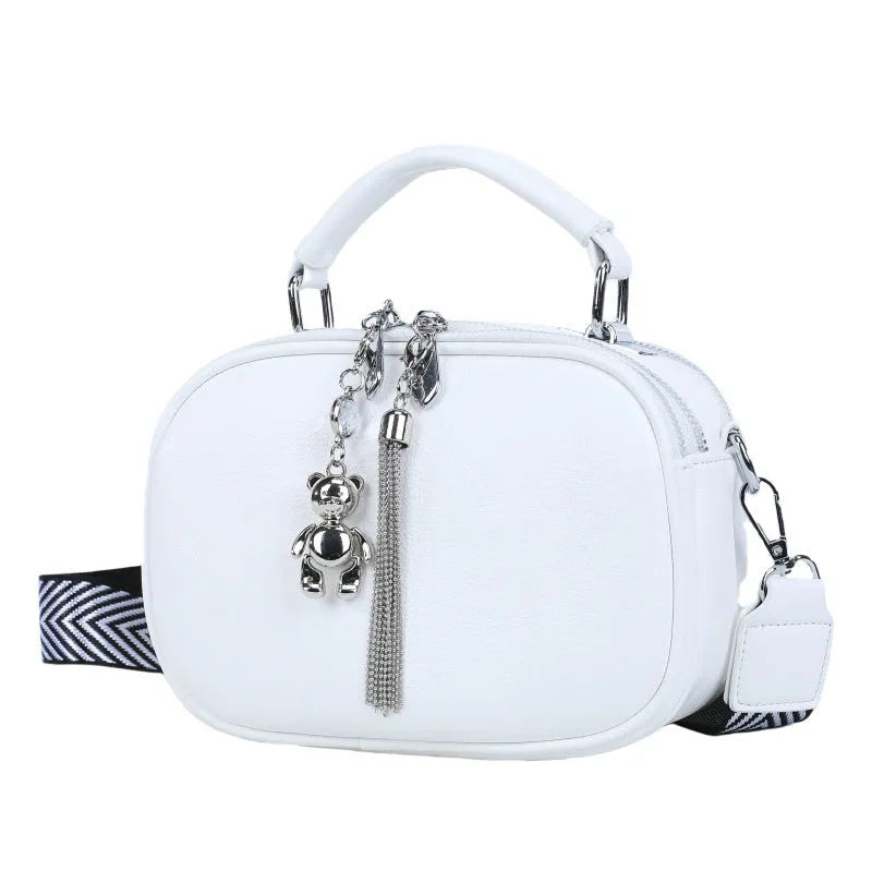 Oval-shaped women's small square handbag in PU with stitching detail and double straps.