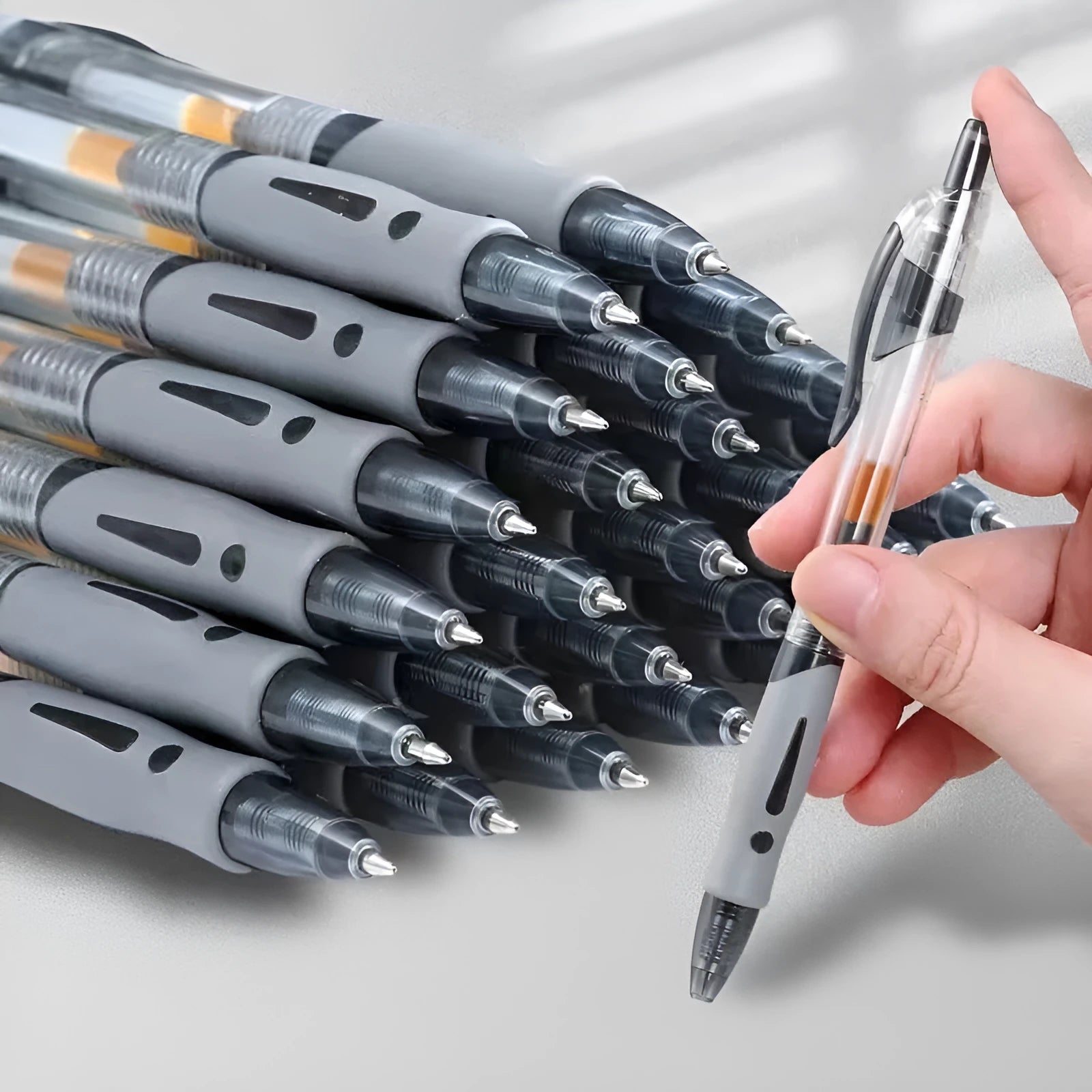A neutral-colour gel pen with a 0.5mm fine tip, shown with black, blue, and red ink refills.