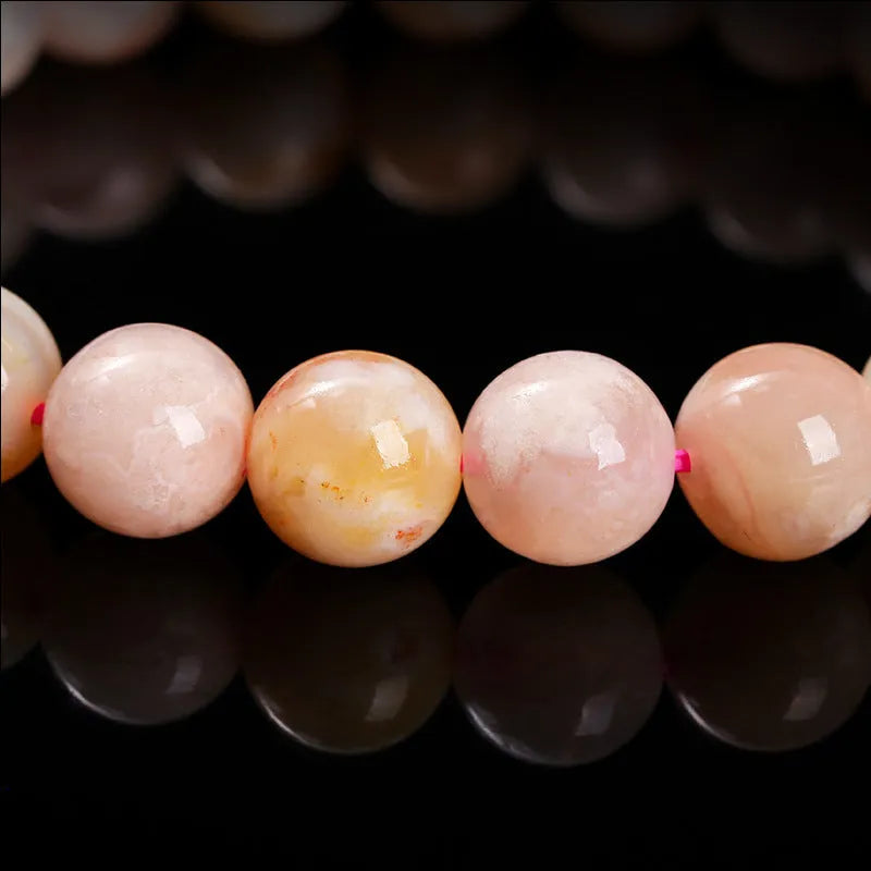 Natural cherry agate bracelet with round beads in a sweet style for women.