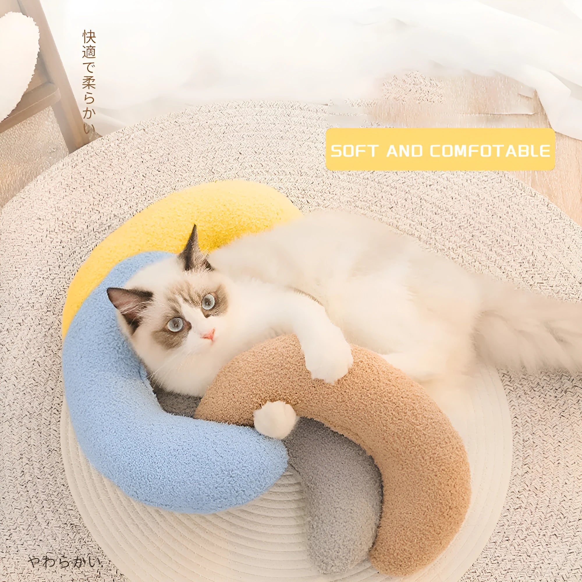 U-shaped blue cat pillow with adjustable collar placed on a sofa