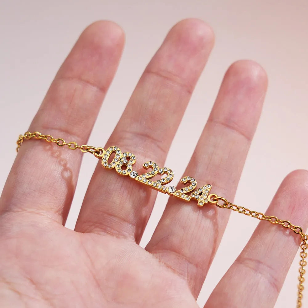 Stainless steel digital bracelet with diamond set numbers on display, shown in a gold colour option.