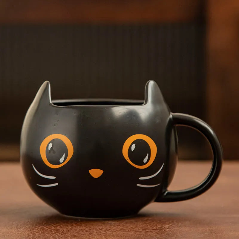 Black ceramic cat-shaped mug with pumpkin decoration and optional spoon lid, 355ml capacity.