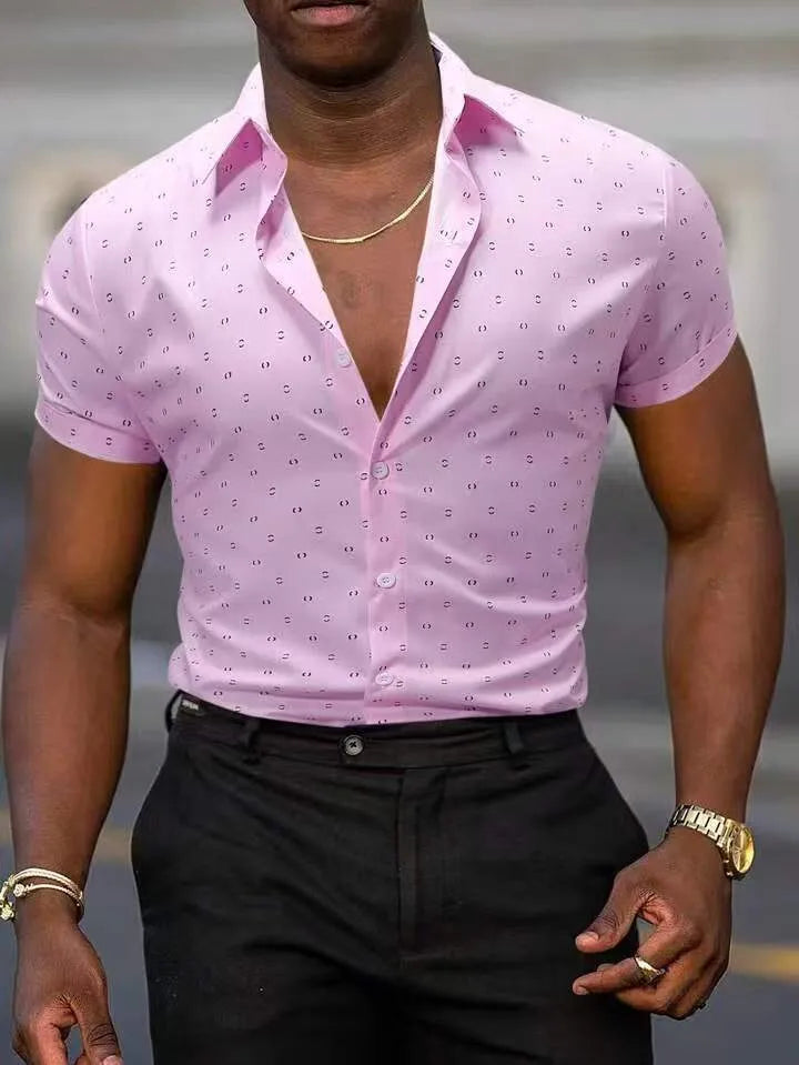 Man wearing a light blue short-sleeved casual shirt with a floral print pattern.