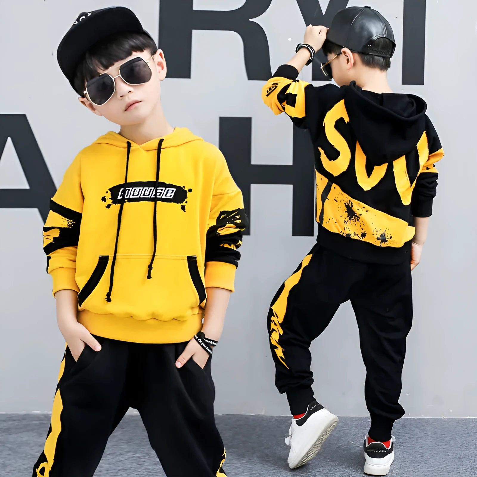Boys' black and yellow hooded cotton tracksuit sets shown in Korean style