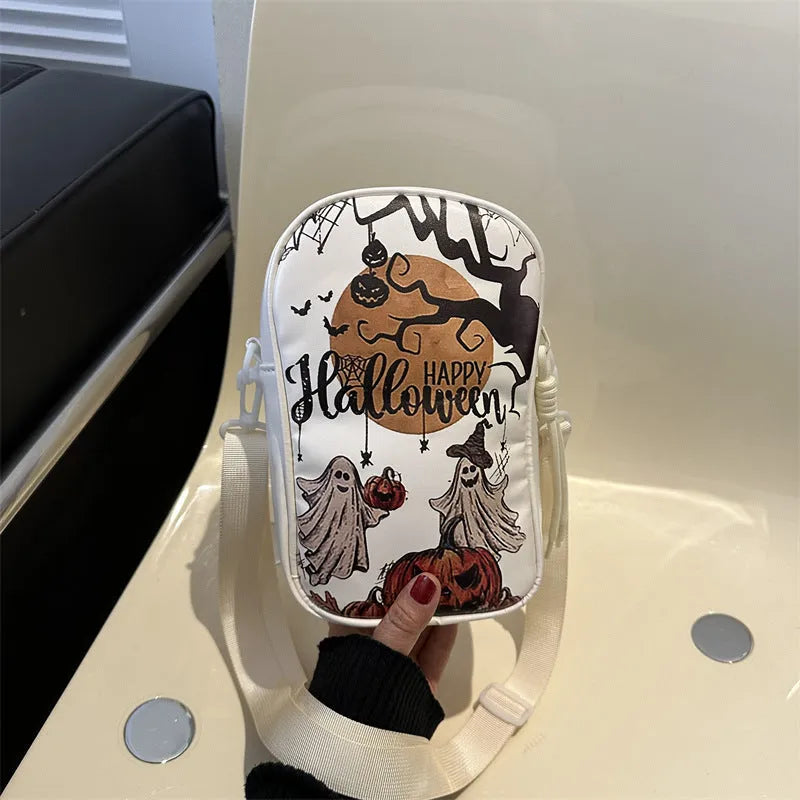 Black Halloween graffiti crossbody bag with cartoon pumpkin, ghost, and bat print, shown with adjustable strap.