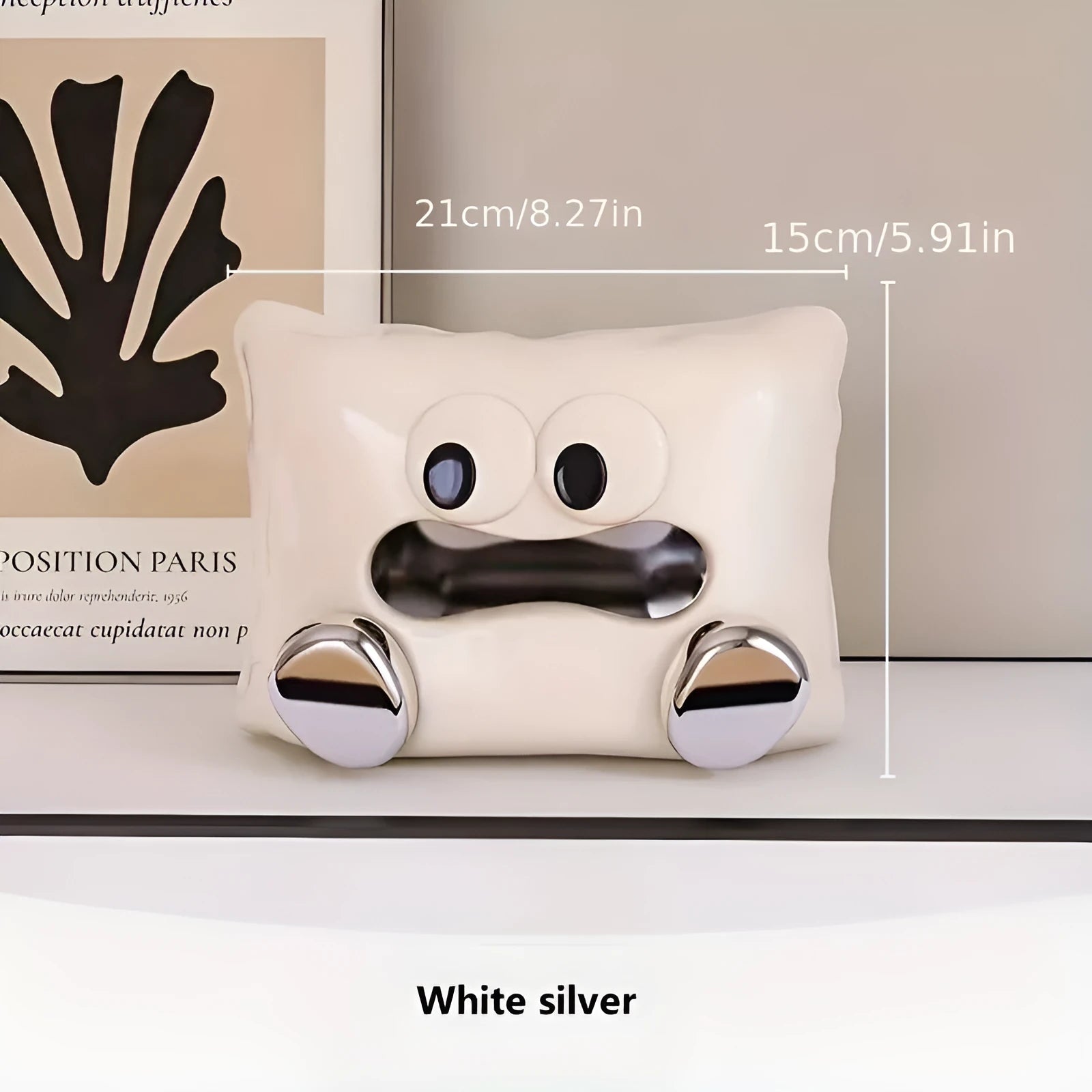 A white ceramic tissue box holder on a wooden coffee table.