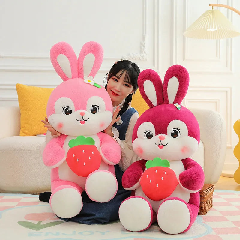 Cartoon strawberry rabbit plush toy doll pillow in pink sitting on a surface