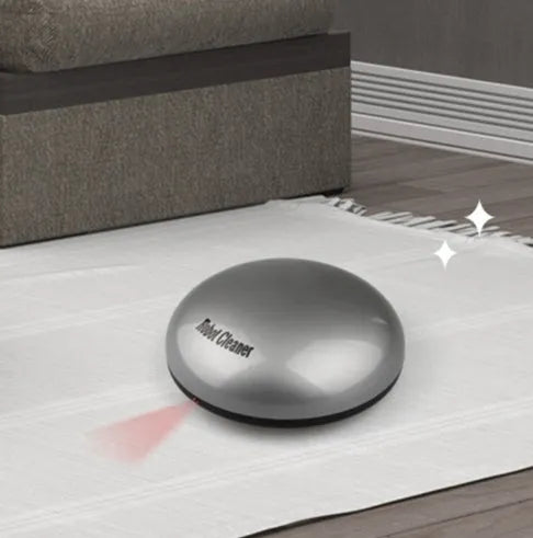 Compact silver automatic vacuum cleaner robot on a wooden floor