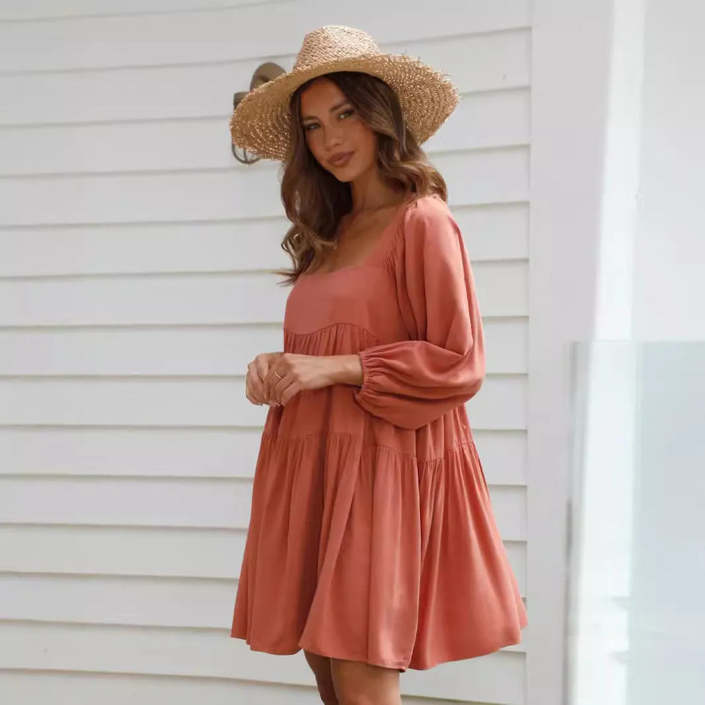Orange children's pullover dress with square collar, puff sleeves, and backless A-line design.