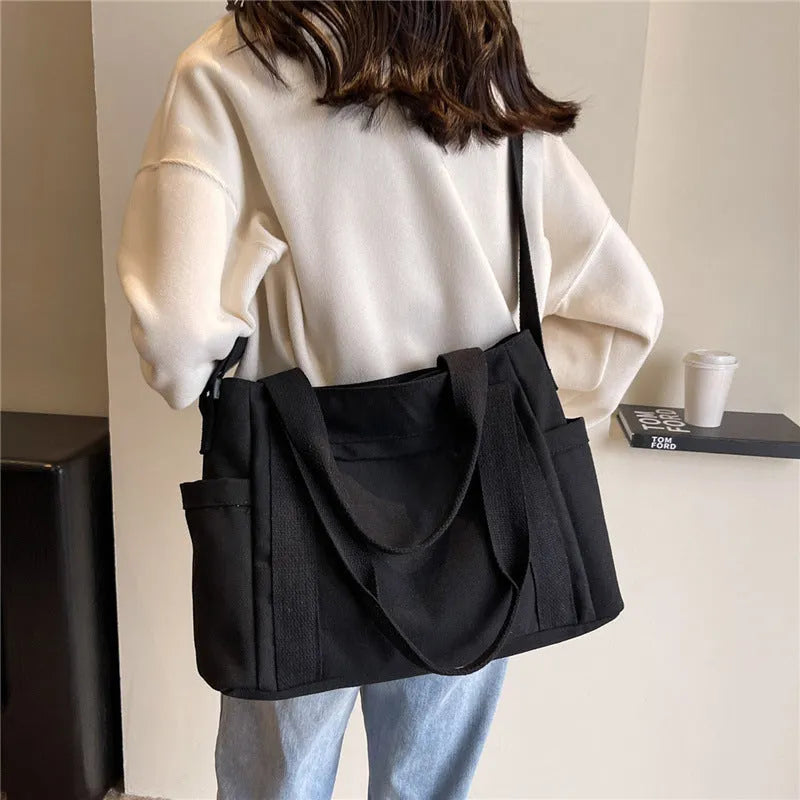 Large capacity polyester canvas shoulder tote bag with internal phone compartment in solid colour