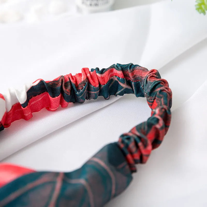 Red cloth headband with banana leaf cross design, elasticated hairband for women