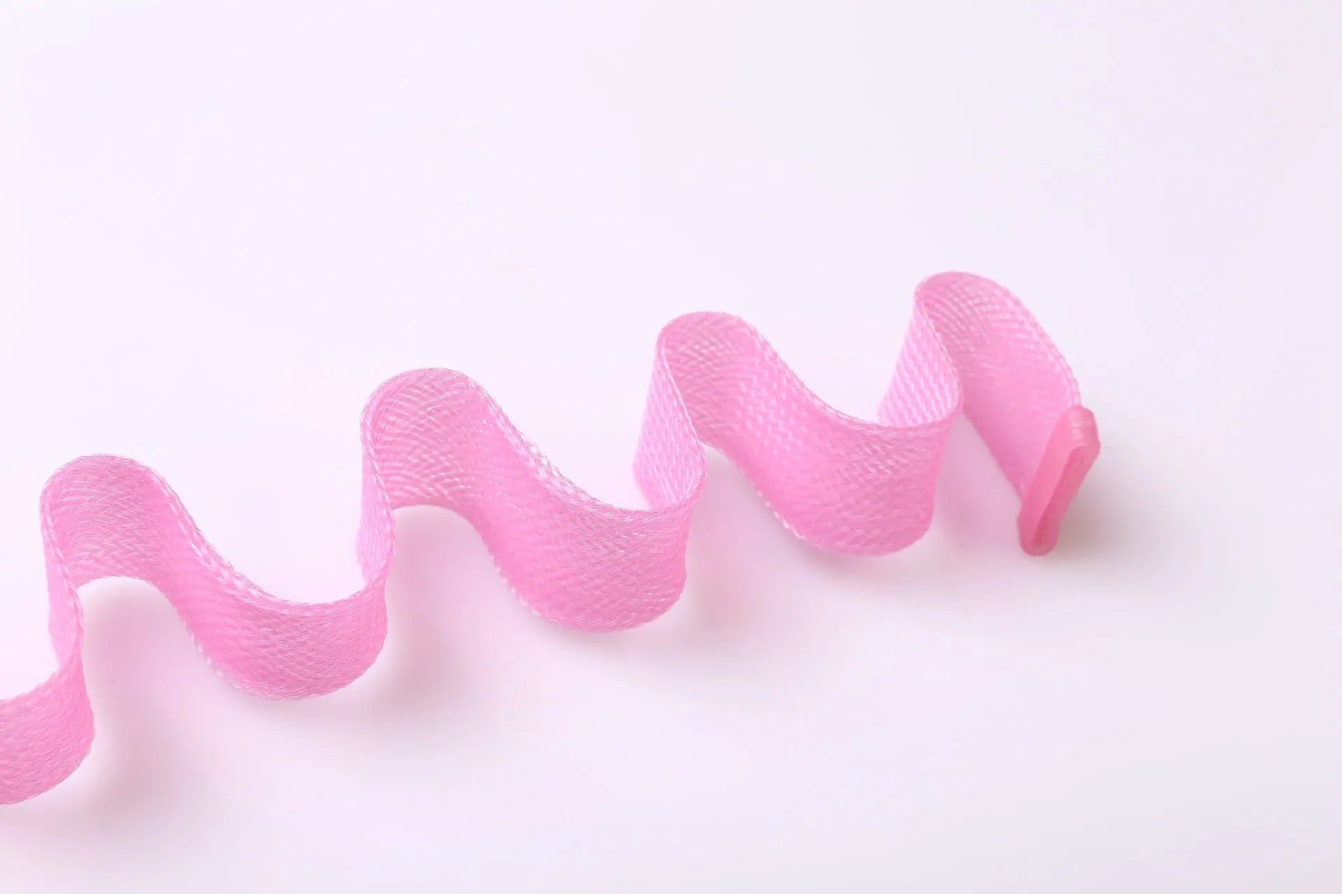 Twelve manual hair curlers in blue orange on a flat surface, 30cm length per curler